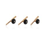 A set of three of diamond and onyx-set studs by Cartier, each centred with a circular-cut diamond