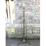 An Art Nouveau brass telescopic oil lamp standard, the central stem flanked by whiplash supports,