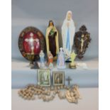 A collection of religious iconic memorabilia to include standing plaster figures, a bone carving