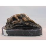 Cast bronze figure of a reclining nude on a naturalistic base, signed Milo, upon a black marble