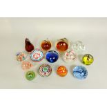A collection of thirteen various glass paperweights to include Scottish and Italian examples