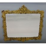 Venetian style gilt wood and gesso wall mirror with bevelled glass plate and floral borders, 44 x 48