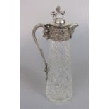 Silver plated cut glass claret jug, the hinged lid mounted by a rampant lion holding a shield,