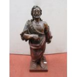 An antique terracotta figure in the form of a saint or biblical character, with original