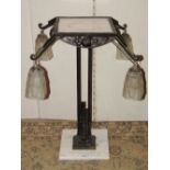 An Art Deco table lamp the painted metal frame and supports with foliate detail supporting four