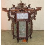 A Chinese hanging lantern of hexagonal form, the wooden frame with pierced fretwork detail and