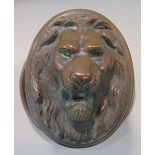 Good large Regency copper door handle, cast with a lion head mask, with circular back plate;