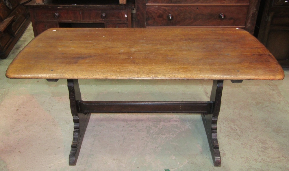 A dark stained elm and beechwood refectory table (possibly Ercol) the rectangular top with moulded