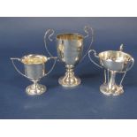 Three silver trophies, one in the Art Nouveau manner with stylised gold club supports, maker Kemp