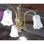 A good quality Edwardian cast brass three branch ceiling light with faceted lobed glass shades