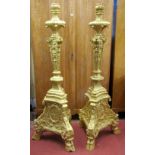 A pair of substantial cast torcheres or lamp standards on tricorn bases, with hoof supports and