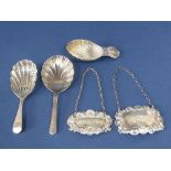 Three silver caddy spoons to include a Georgian style spoon with scallop shell bowl and cast scallop