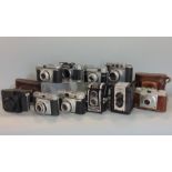 A dozen vintage cameras, a mix of 35 mm and 120 film, German and Japanese, some in original cases