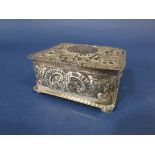 Victorian silver cigarette box, embossed with scrolled foliage, the hinged lid fitted with a