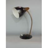 A vintage table lamp with coiled brass bendy stem pierced shade and domed platform base