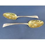 Pair of late Georgian silver berry spoons with silver gilt bowls and engraved handles, maker