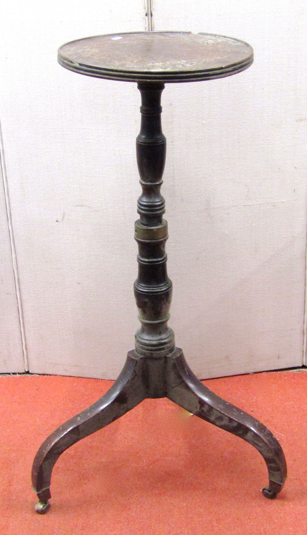 A torchere, the circular top raised on a turned column and tripod base
