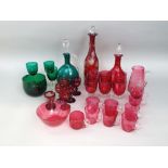 A mixed collection of mainly cranberry glassware to include decanters and goblets, together with a