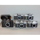 Five Russian Zenit camera bodies, two with 1980 Olympic Games logo and one in case, with strap