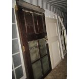 A large collection of reclaimed doors, Georgian style, six panel, two panel, mainly pine, some