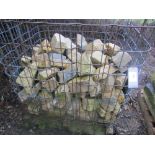 A wire crate of cut building stone, average length 20cm, approx 2 square metres
