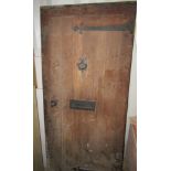 A good quality reclaimed oak exterior door with wrought iron brass fittings, 2 metres x 85 cm