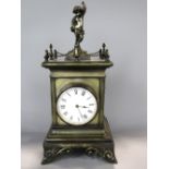 French brass cased figural mantle clock mounted by a cherub with gallery rail, twin cherub type