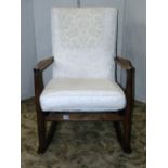 A vintage Parker Knoll rocking chair model number 973-4, with stained beechwood frame, sprung seat