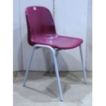 50 moulded plastic stacking chairs, with painted tubular steel supports (one example on view, the