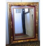 A large contemporary wall mirror of rectangular form with bevelled edge plate within a stepped and