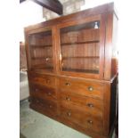 A substantial pitch pine dresser, the upper section enclosed by a pair of rectangular glazed