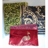 Textile pieces including a burgundy panel with central peacock figure on a velvet ground, framed