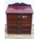 An Edwardian walnut sheet music cabinet fitted with four long drawers, with patent fall fronts and