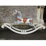 A carved wooden carousel horse with hand painted saddle, bridle and dappled finish, later adapted as