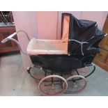 A vintage Silver Cross coach built pram with sprung frame and wire spoke wheels with hard rubber