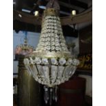 A cut glass and brass framed basket chandelier