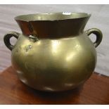 An antique bronze cauldron, with loop handles, 30cm diameter