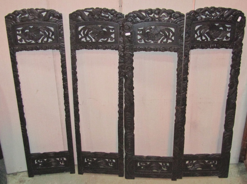 A small Japanese four fold screen with decorative carved framework (AF) lacks panels, together