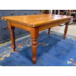 A Victorian style stripped pine farmhouse kitchen table the rectangular top with rounded ends raised