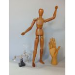 An artists dummy with articulated limbs together with a further artists hand dummy with