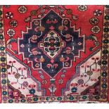 Persian Tabriz runner, with three medallion decoration upon a red ground, 240 x 90cm