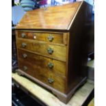 A Georgian mahogany bureau, the fall flap enclosing a fitted interior of small drawers and pigeon