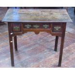 A Georgian oak low boy fitted with three drawers raised on square cut supports with shaped feet,