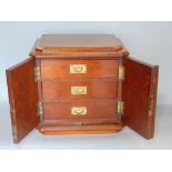 Early 20th century mahogany table top cabinet, the stepped top with canted corners over two hinged