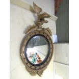 A Regency style convex mirror, the 40 cm diameter plate within a traditional reeded slip and