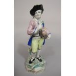 An early 19th century hollow cast pottery model of a hurdy-gurdy player in 18th century style