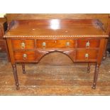 A Regency mahogany side table, with three quarter gallery, over an arrangement of five drawers and