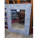 A large contemporary wall mirror of rectangular form, the mirror plate set within a wide floral