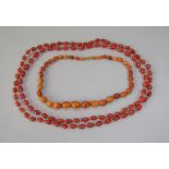 Graduated oval amber bead necklace, 20g and a further long agate bead necklace (2)