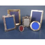 Three silver applied easel picture frames, two square examples and one tondo, together with three